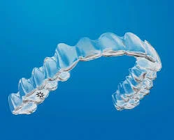 Transparent clear aligner appliance on a blue background
