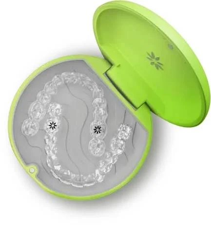 Clear Invisalign aligners stored in a green protective case